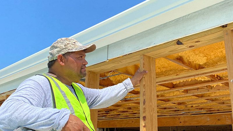Gutters being installed in new home