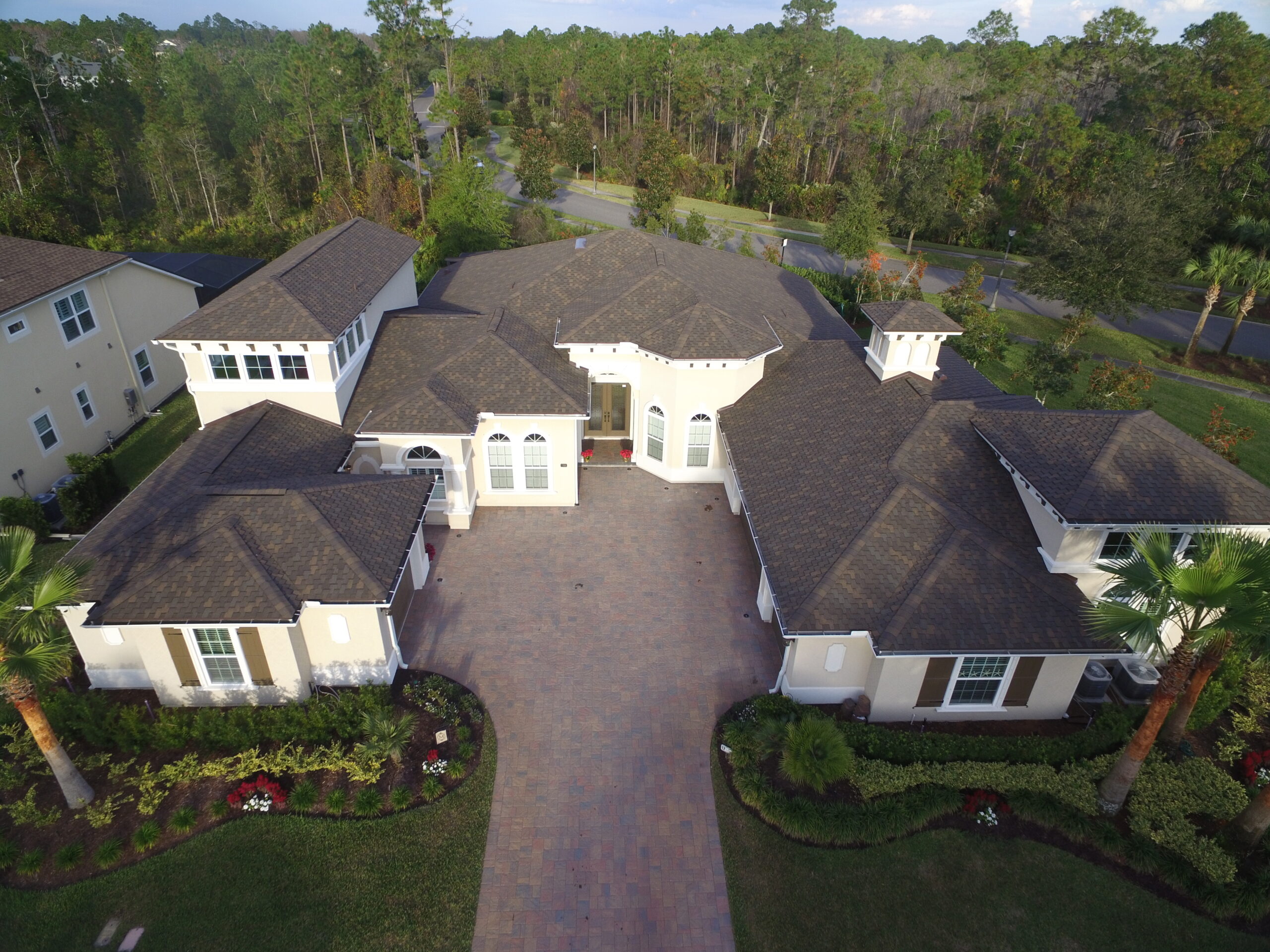 large home with dark shingle roof