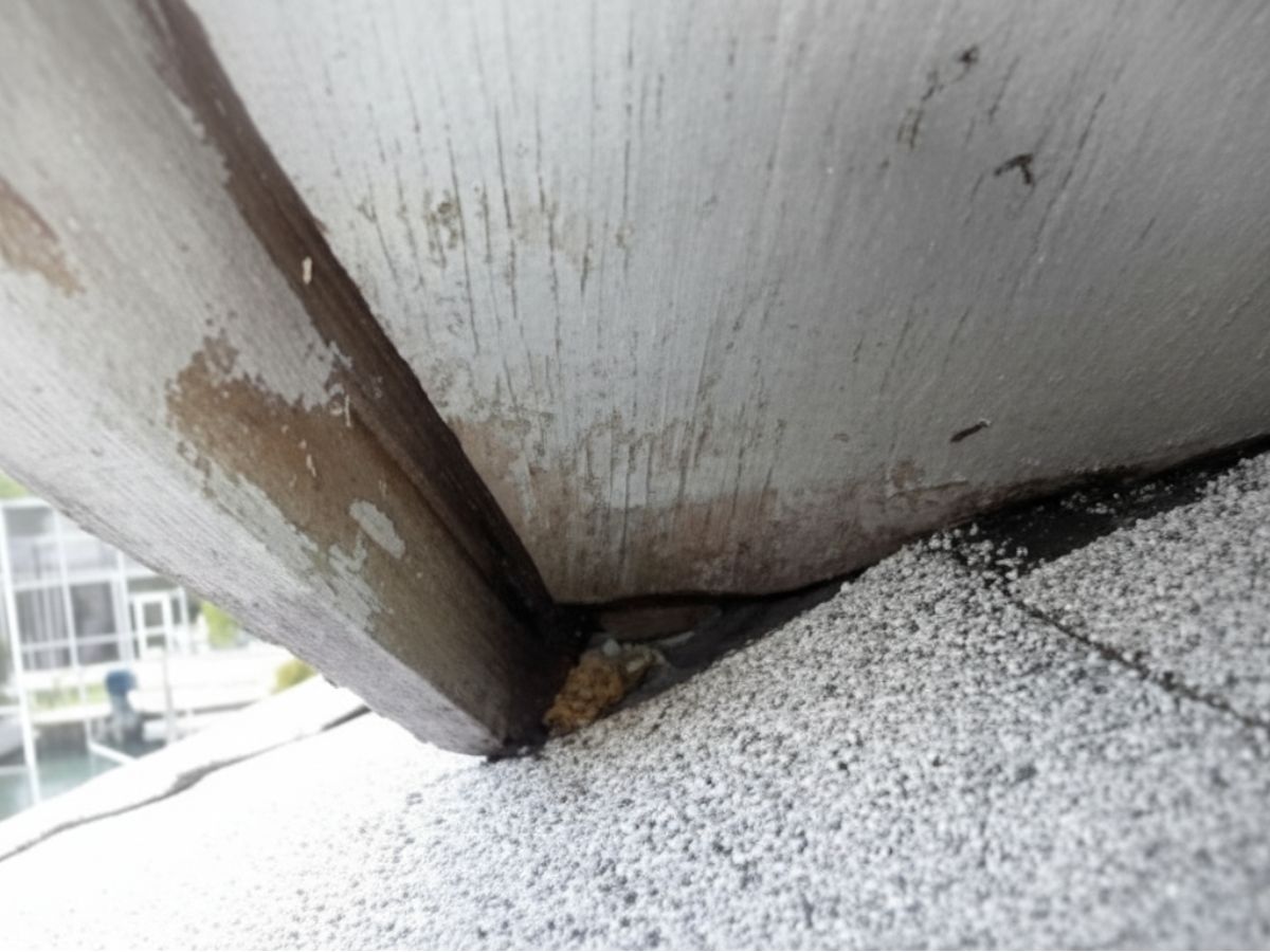 Water damage at roof-to-wall intersection with deteriorated flashing