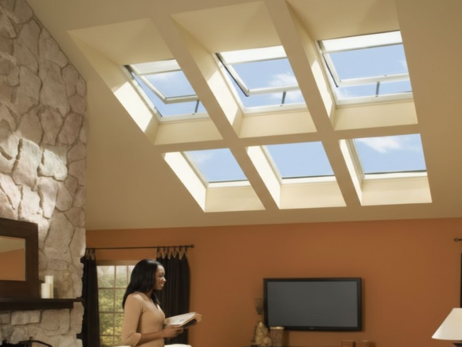 Living room interior with multiple ceiling skylights providing abundant natural light and enhancing energy efficiency