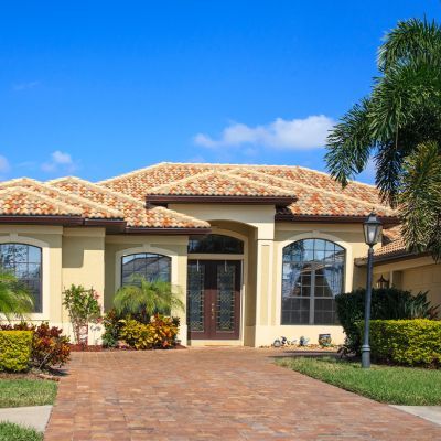How Long Do Tile Roofs Last in Florida? Exploring Their Longevity and Durability 1 beige house with rock walkway and yardlight
